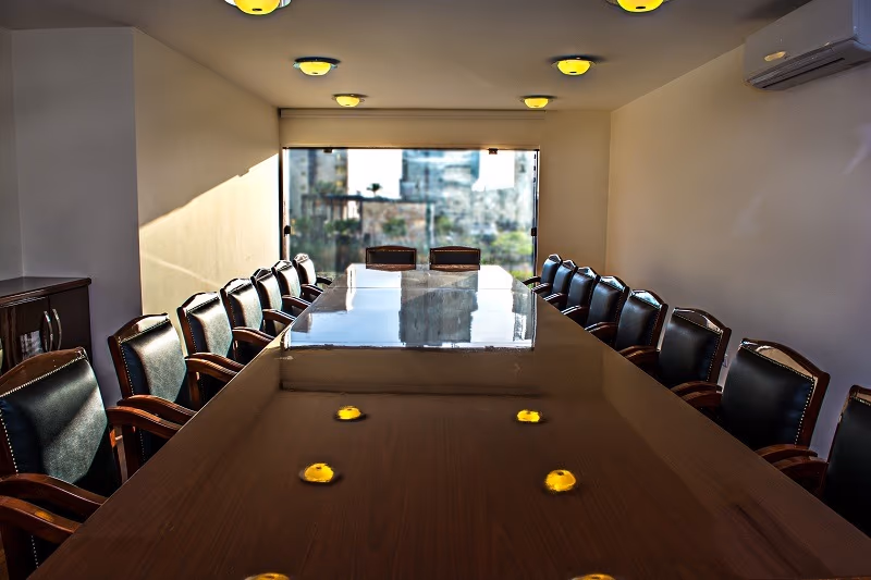 The conference room: one long boardroom table with black chairs down both sides