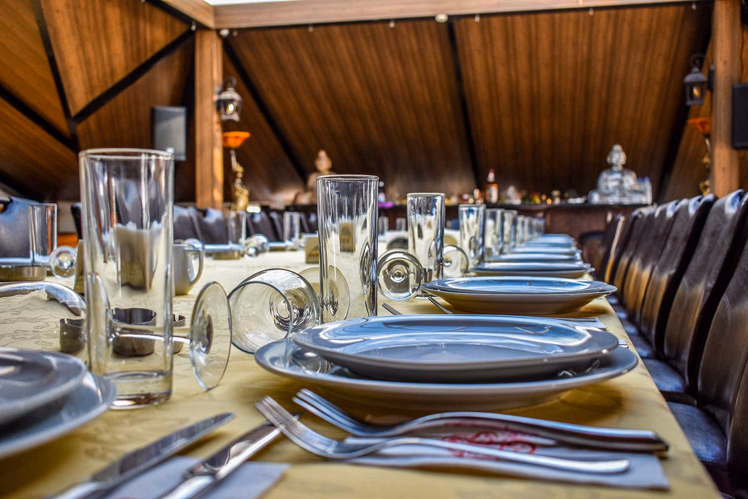 A close view of the table, set with glassware and folded napkins
