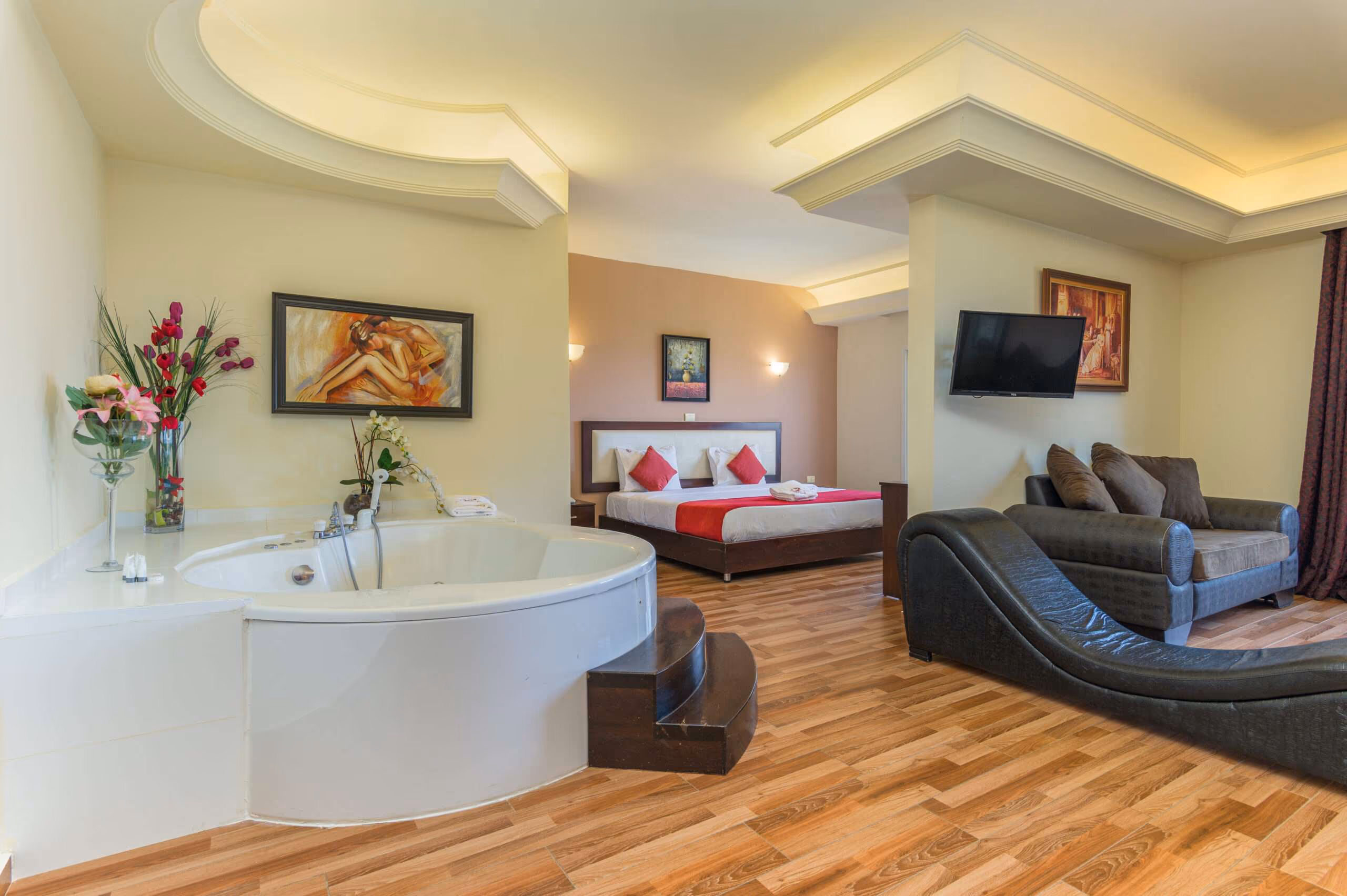 The King Suite: a whirlpool tub, a seating area and a television